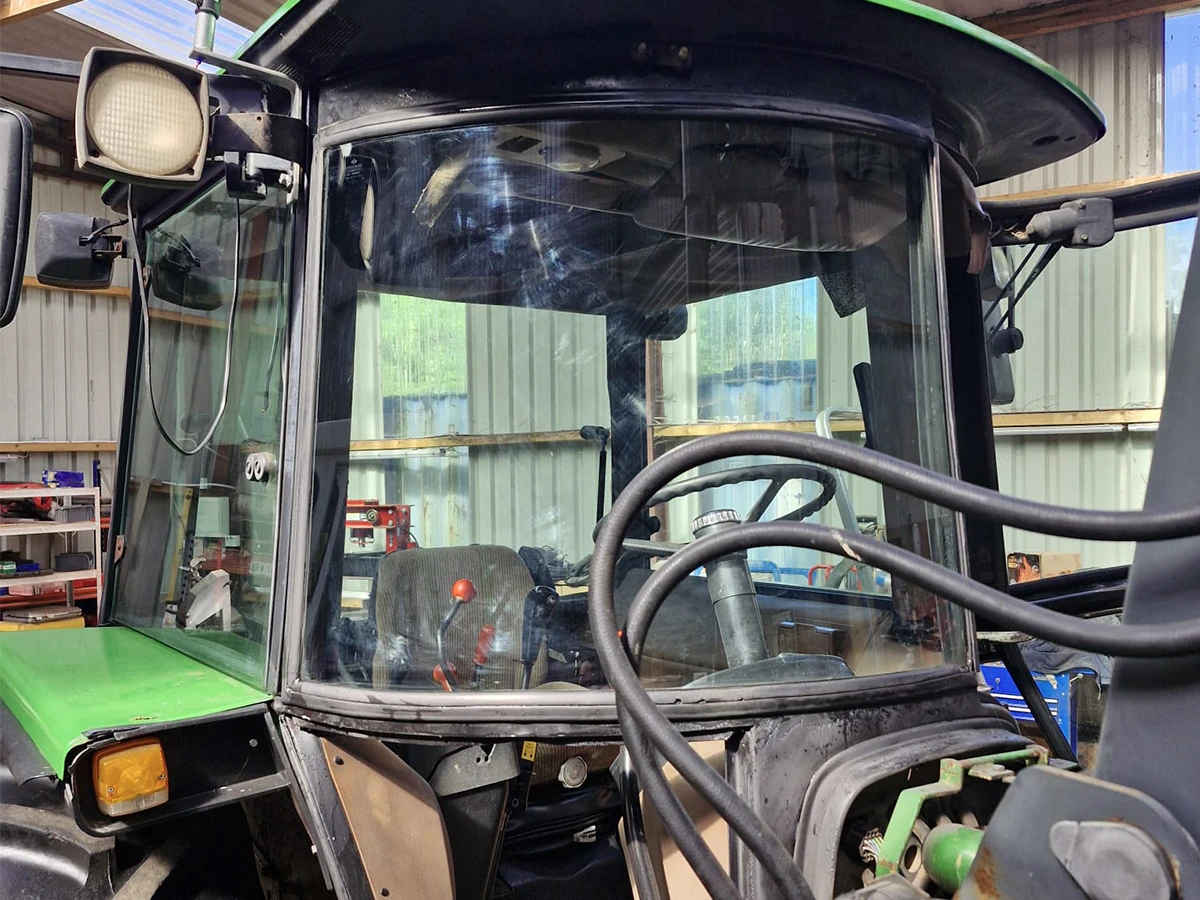 Agricultural tractor with a newly fitted cab glass