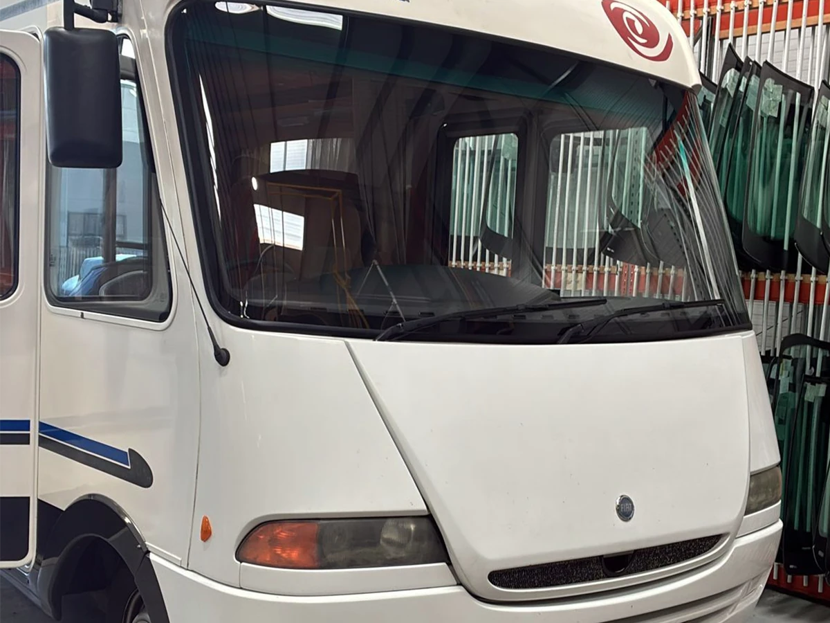 Fiat-based motorhome with a newly fitted front windscreen in the workshop