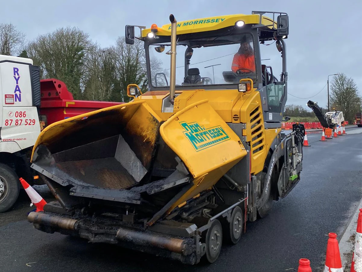 Vögele road paver with replacement cab glass on a resurfacing job