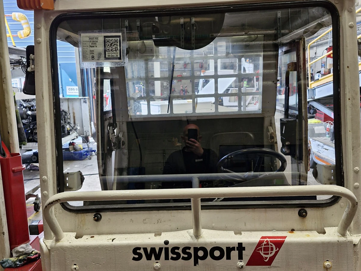 Swissport airport baggage tug with a replacement windscreen