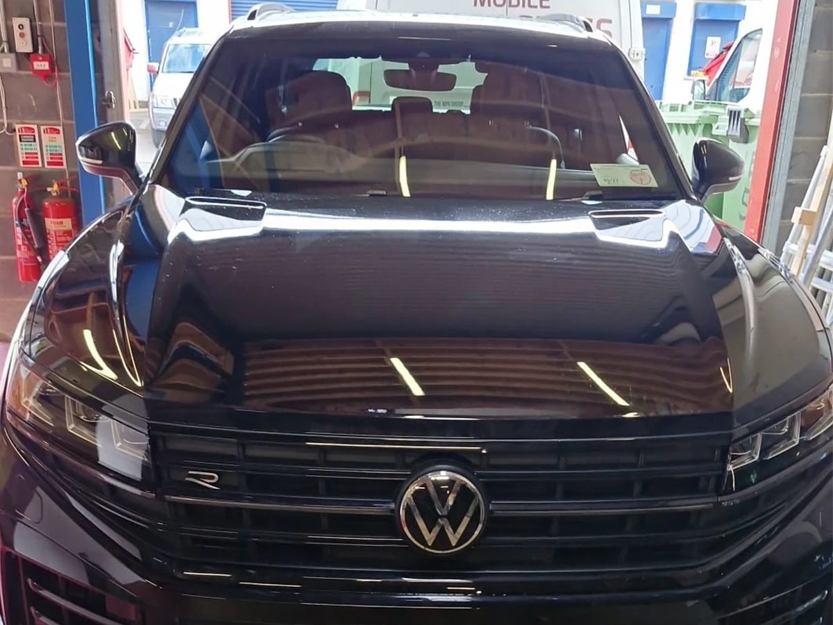 Black Volkswagen with a replacement windscreen in the workshop