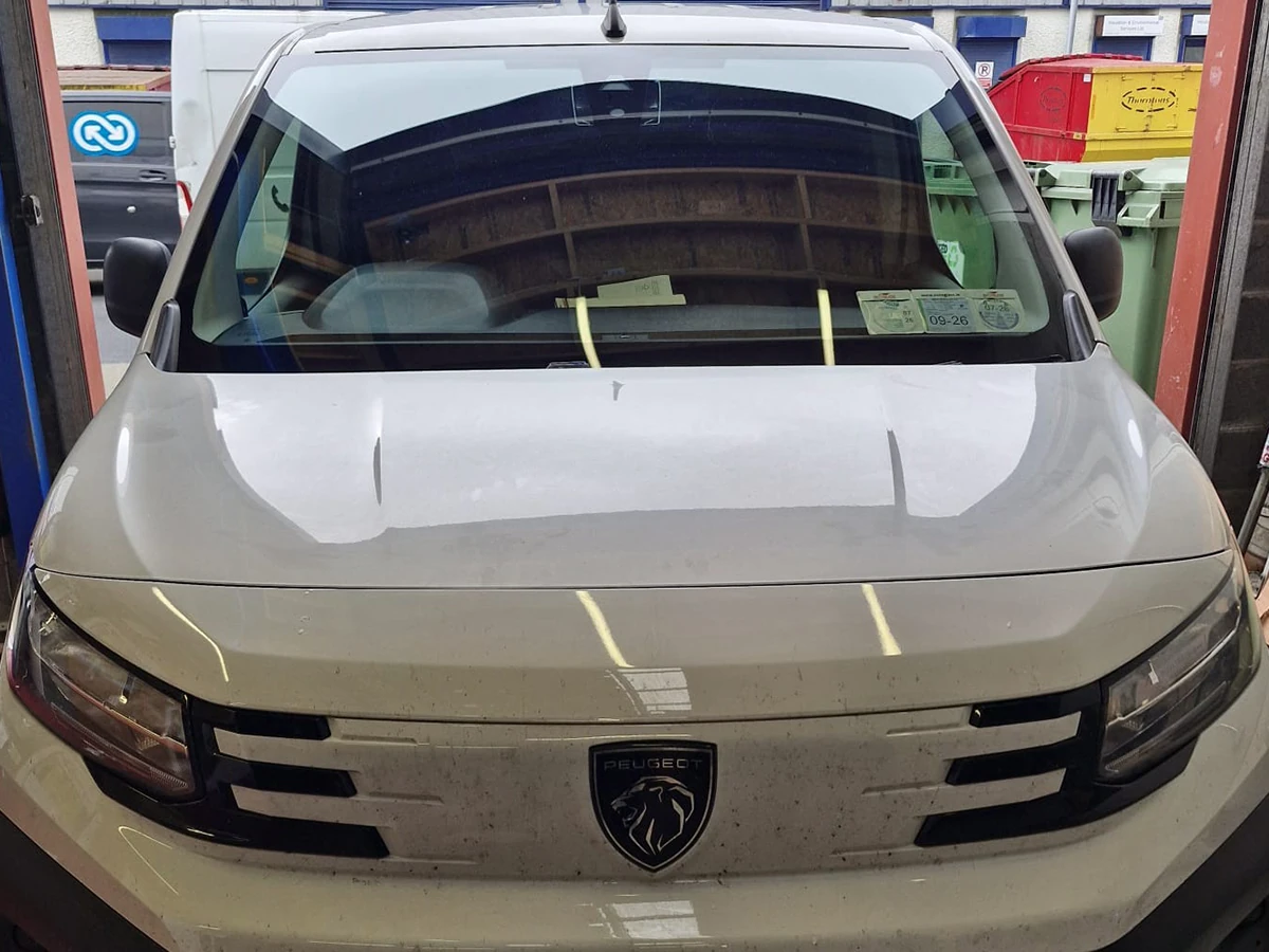 Peugeot van with a replacement windscreen in the workshop